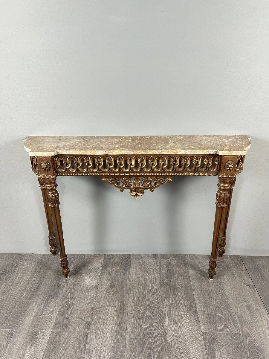 Louis XVI style console in carved wood with a gilded patina, 19th century.