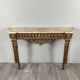 Louis XVI style console in carved wood with a gilded patina, 19th century.