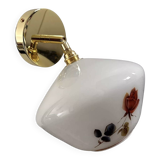 Golden tilting wall light with flowered globe