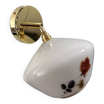 Golden tilting wall light with flowered globe