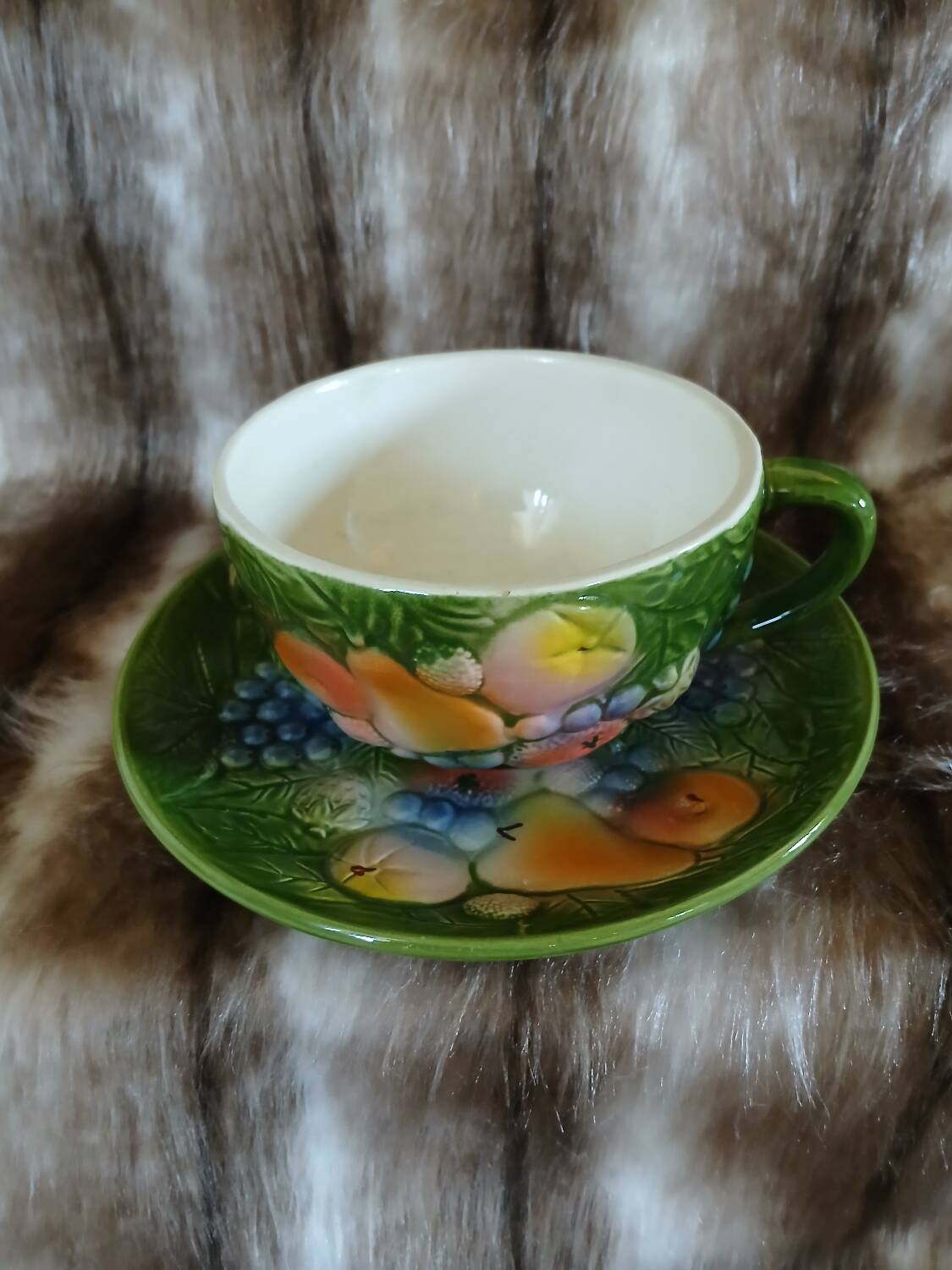 Antique cup and saucer in slipware.