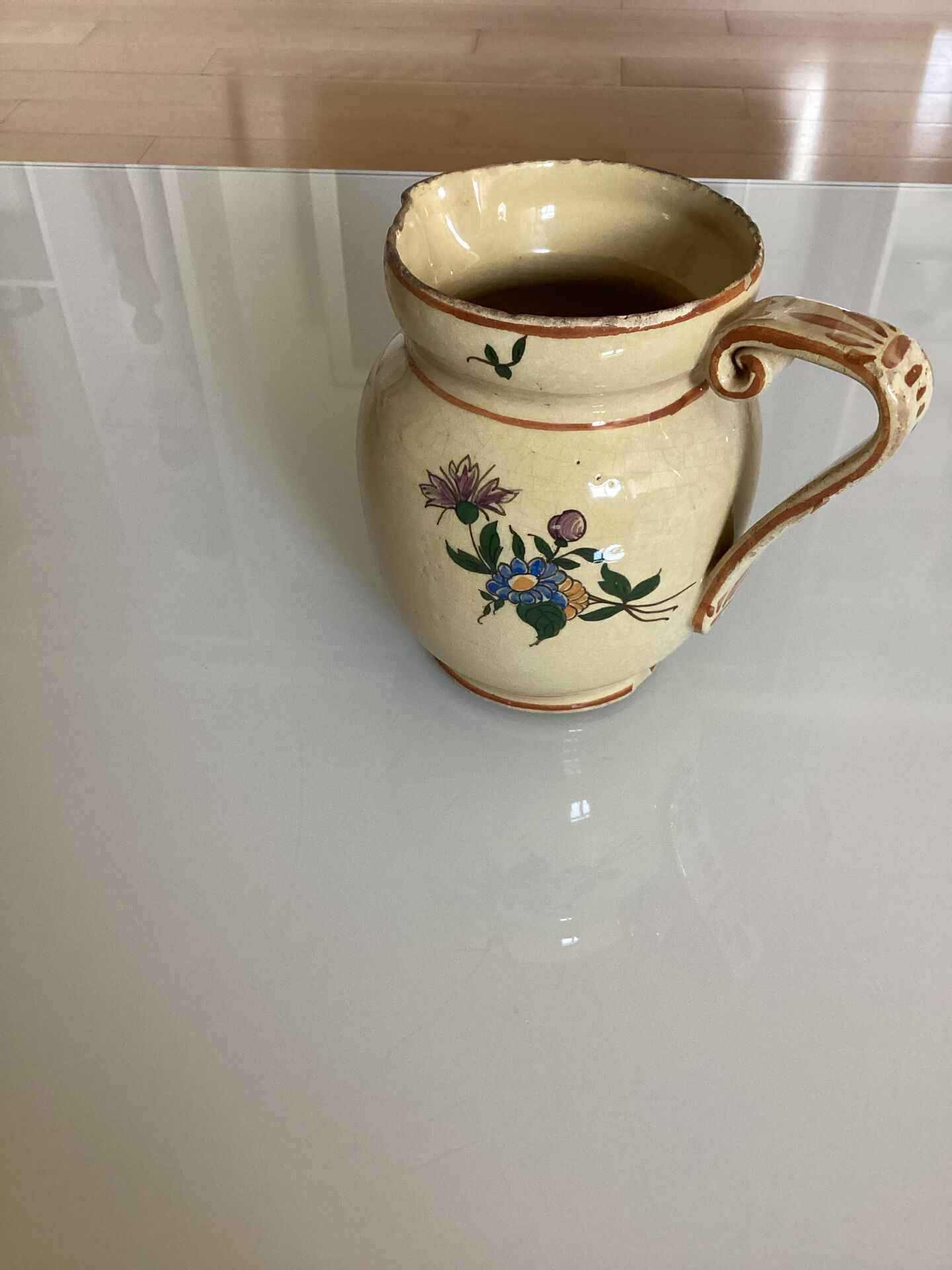 Old ceramic jug with floral decoration