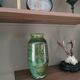 Ancient vase in glazed green terracotta.