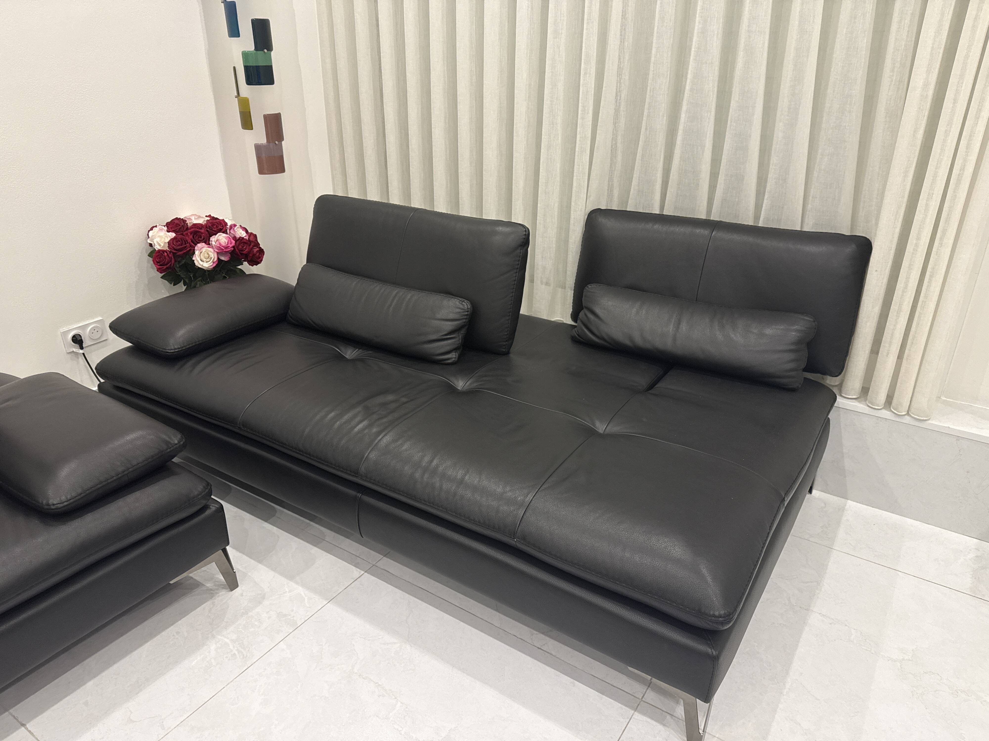 2 black leather sofas roche bobois scenario, one three-seater and one chaise longue.