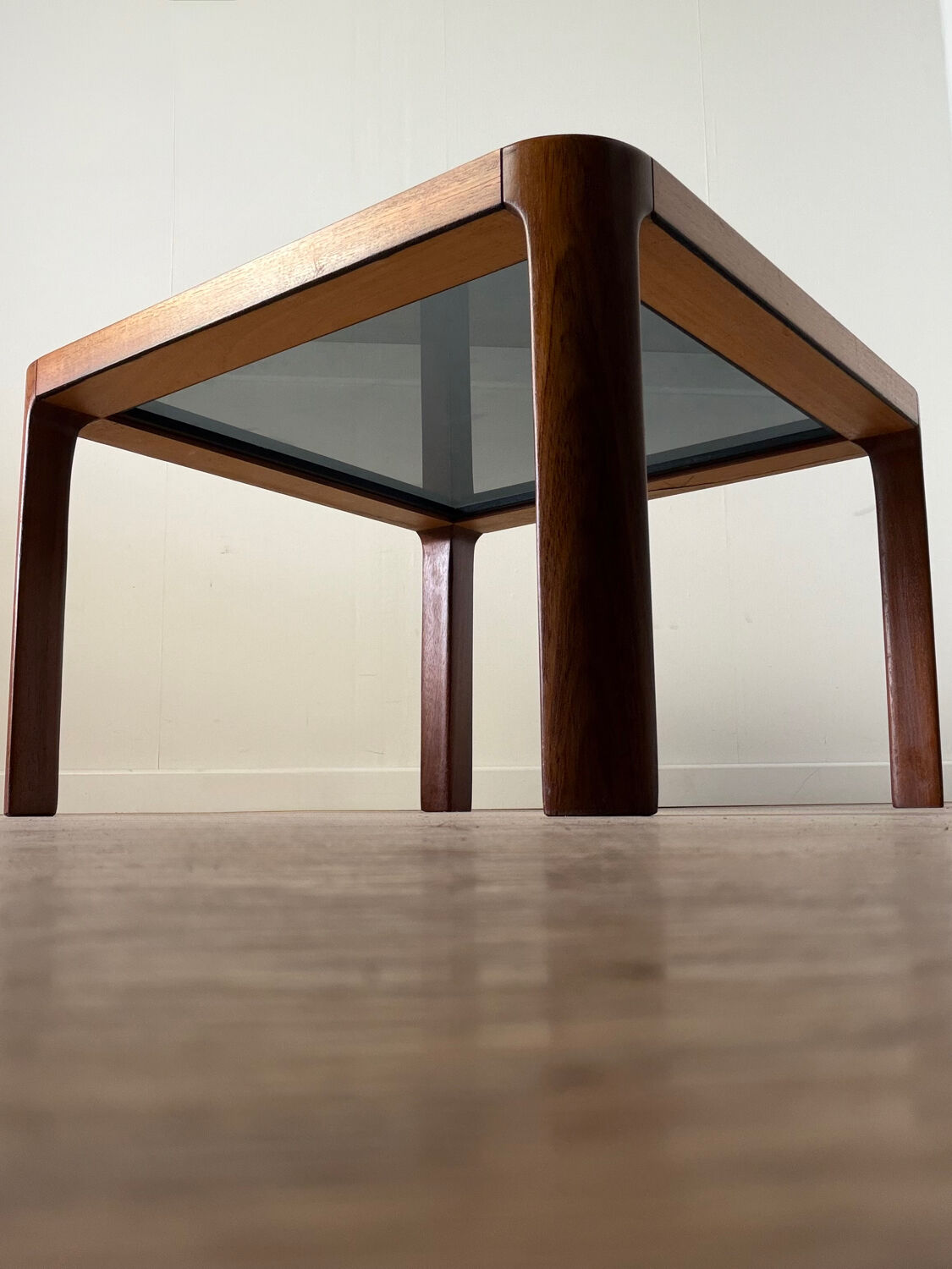 Square wooden coffee table with glass.