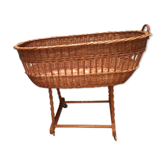 Vintage wicker baby cot on wheels