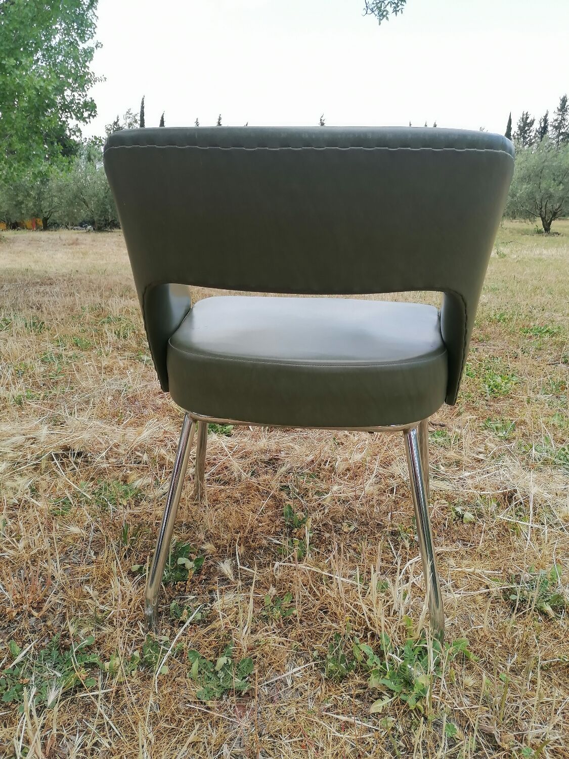 Vintage conference armchair in green skai Roset SNA