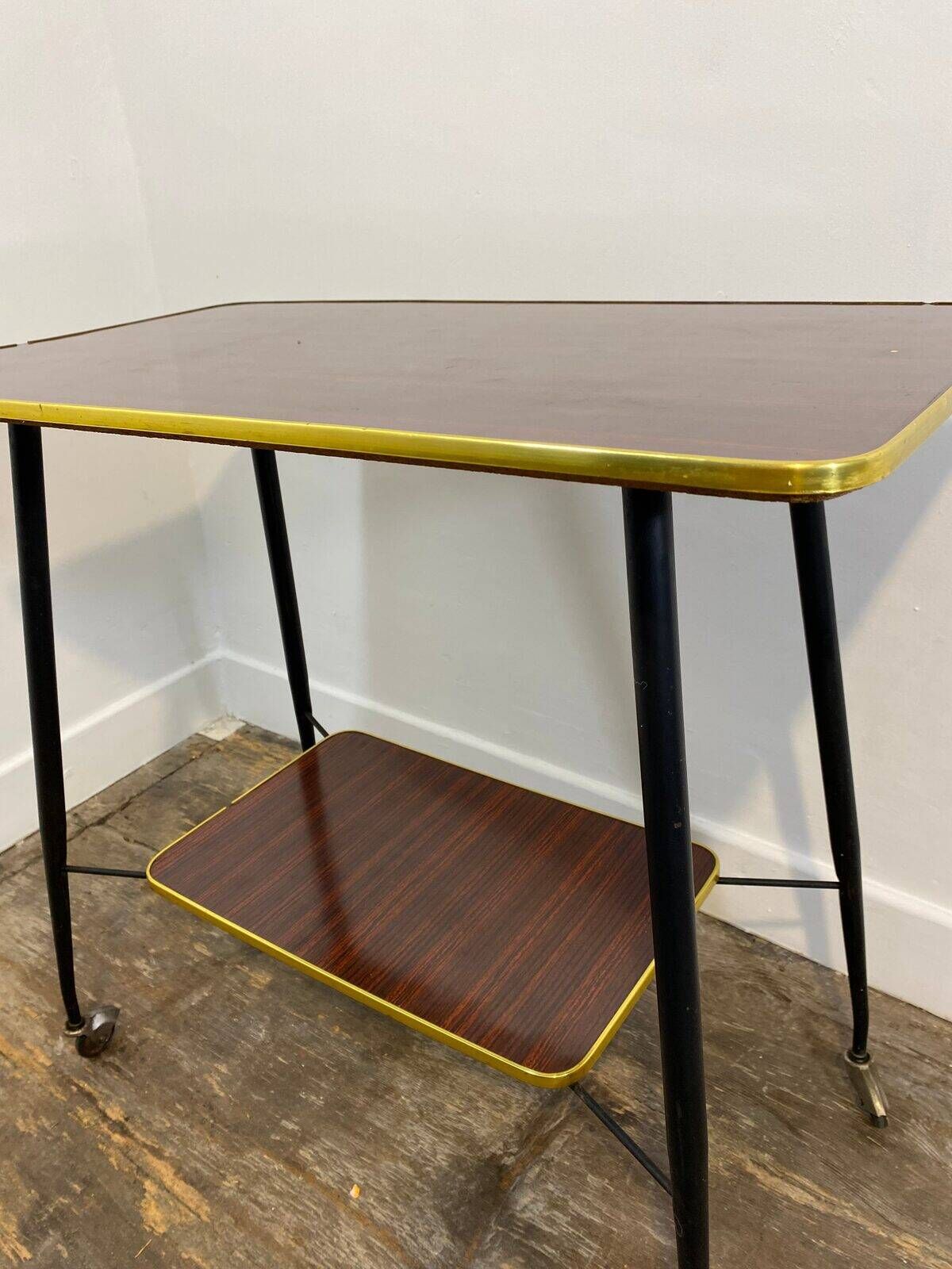 Vintage side table, brass gallery and wheels, 1950s.