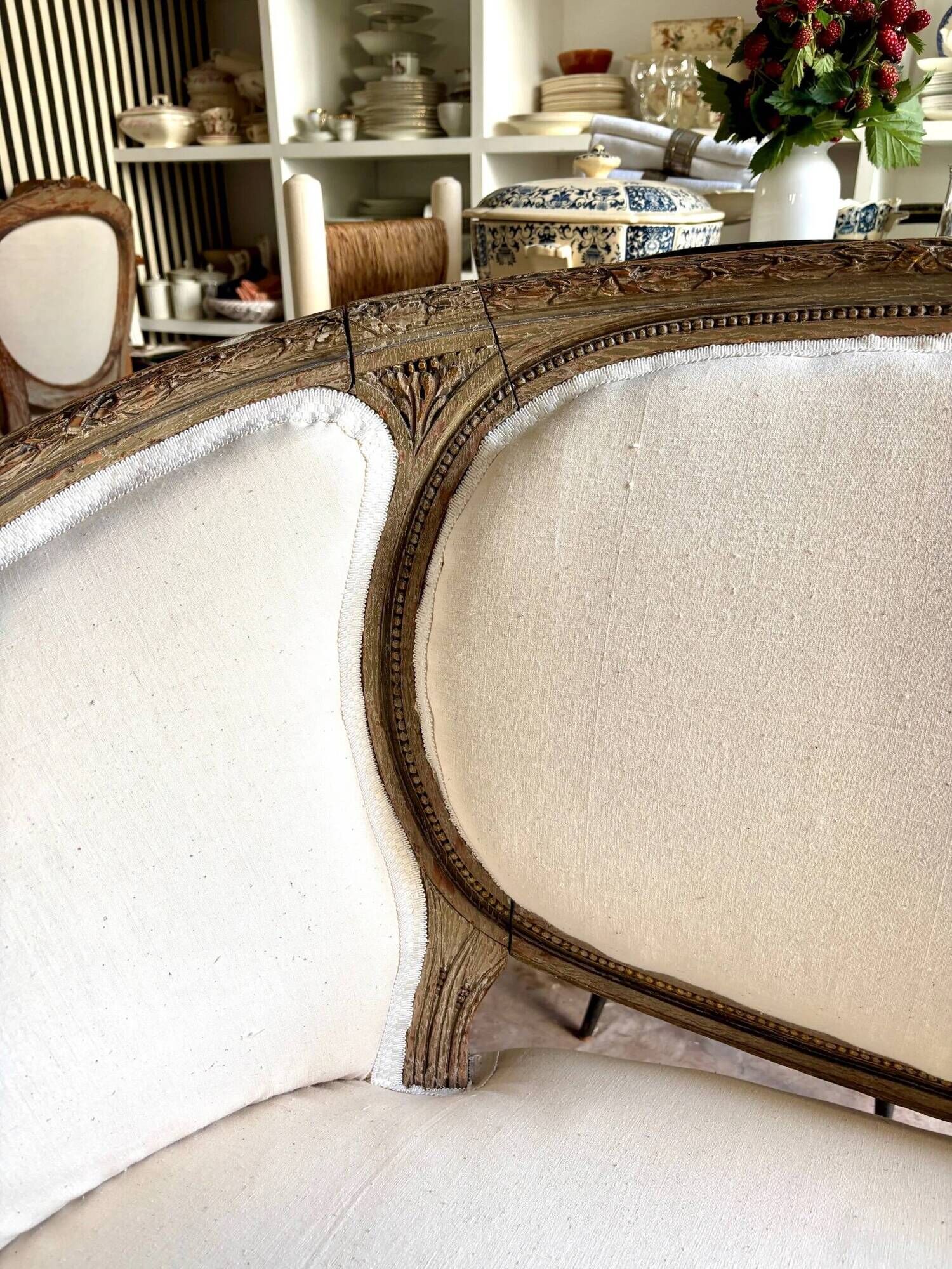 Two-seater basket bench in carved wood and beige mixed fabric, 18th century.