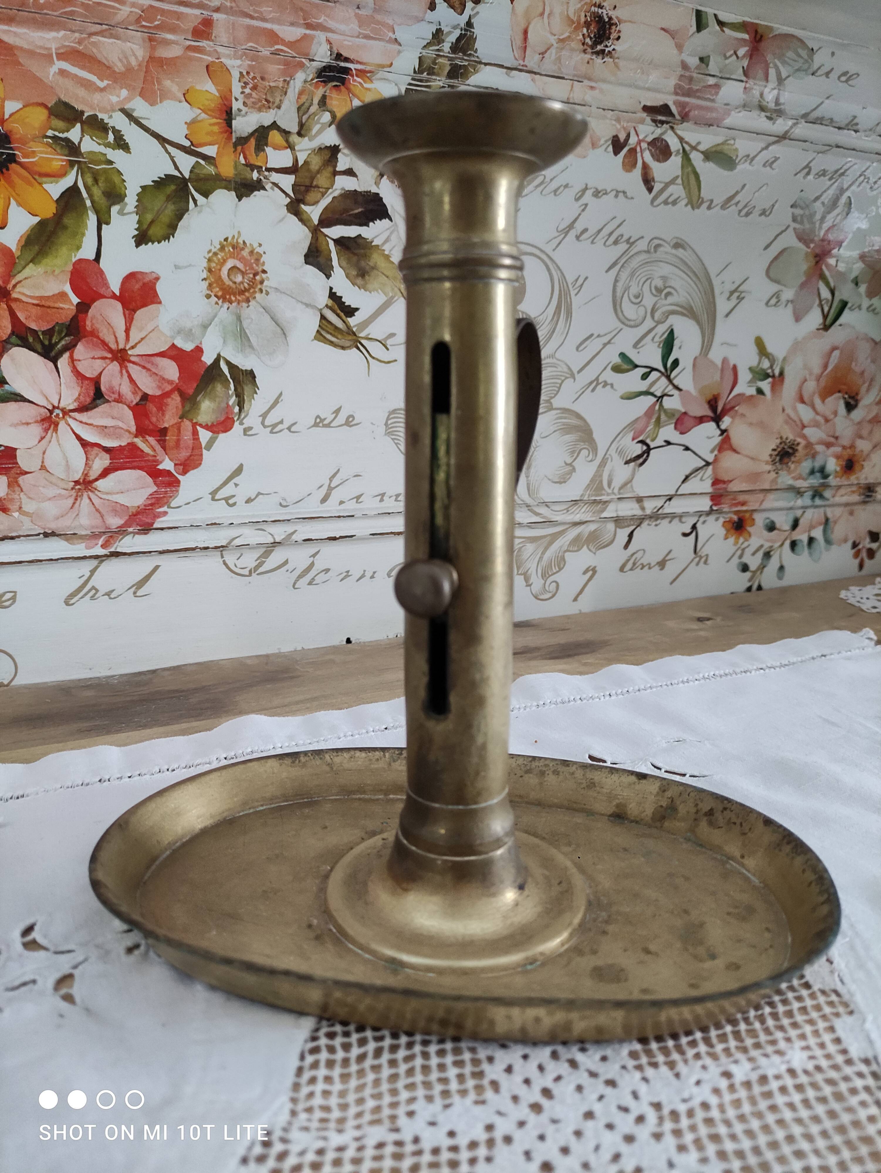 Brass pusher candle holder on oval frame