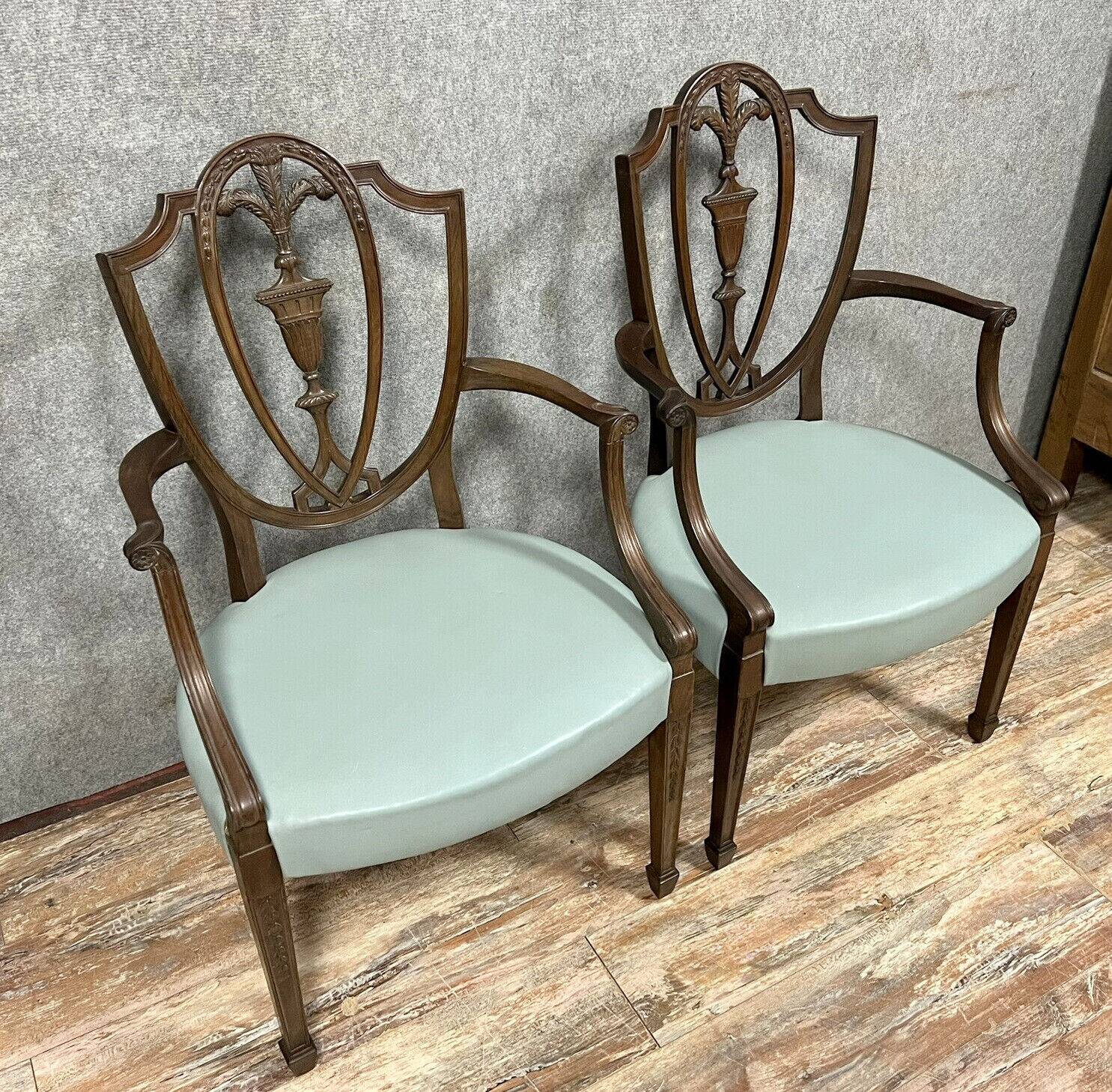 According to George Hepplewhite: pair of 19th century mahogany office armchairs