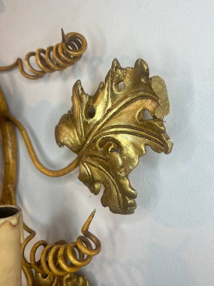 Large pair of wall sconces with vine decorations.