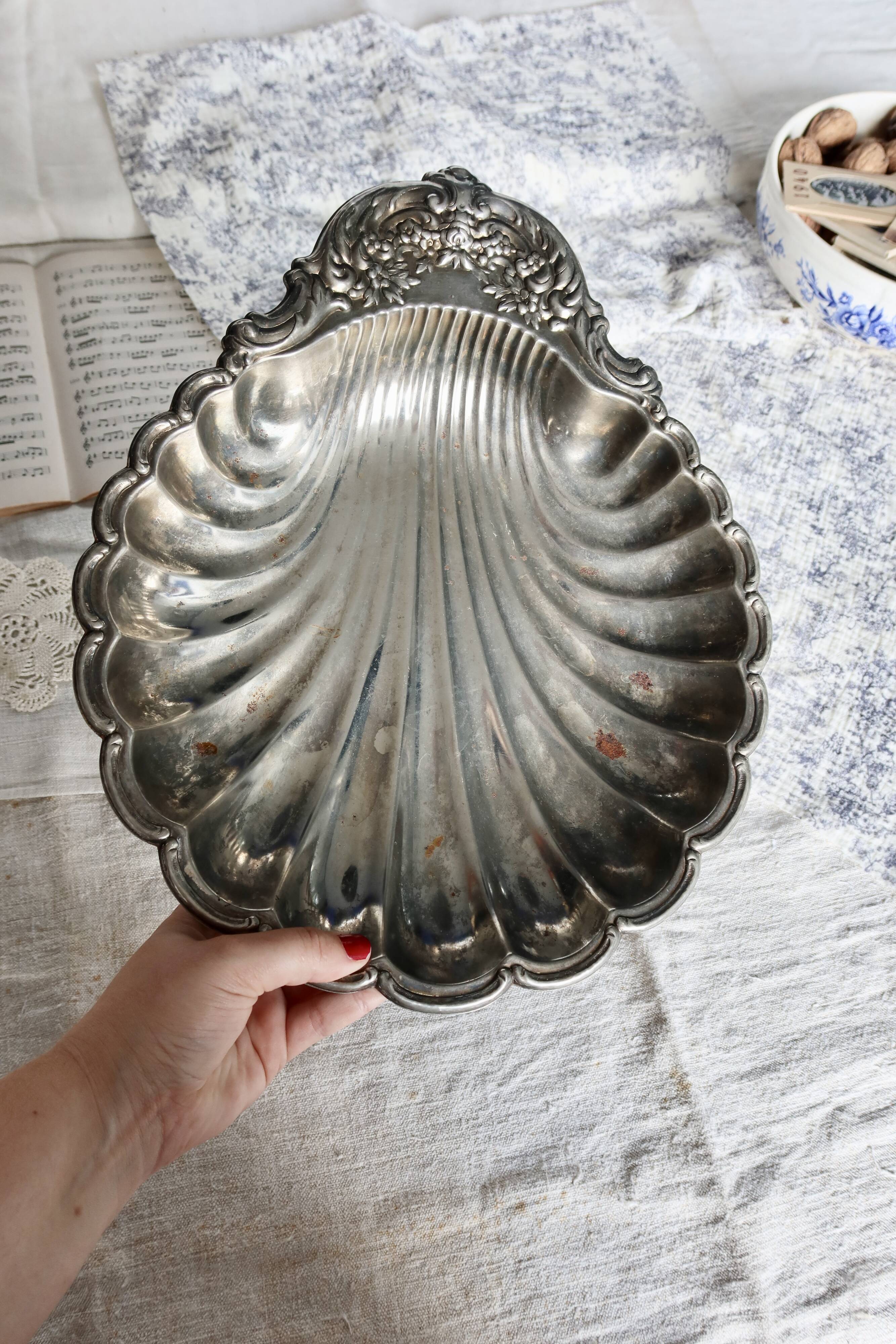 Large vintage shell-shaped platter in shiny silver-plated metal.