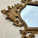 Carved and gilded wooden wall mirror.