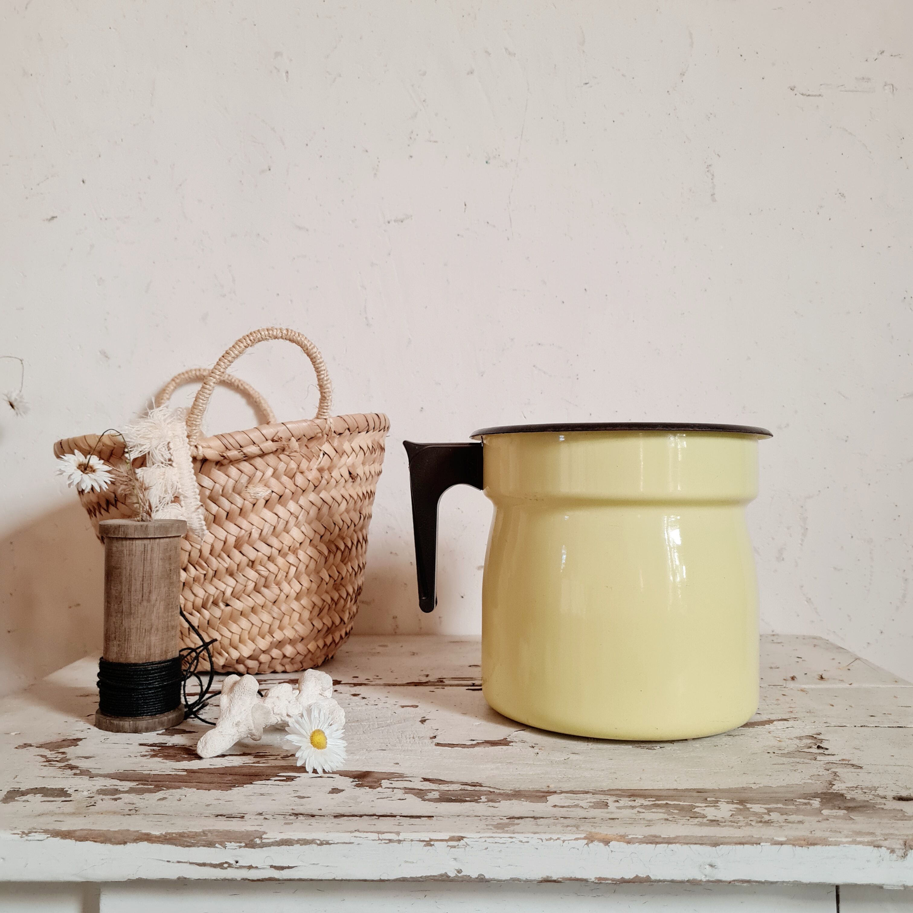 Old pitcher in yellow enamelled sheet metal