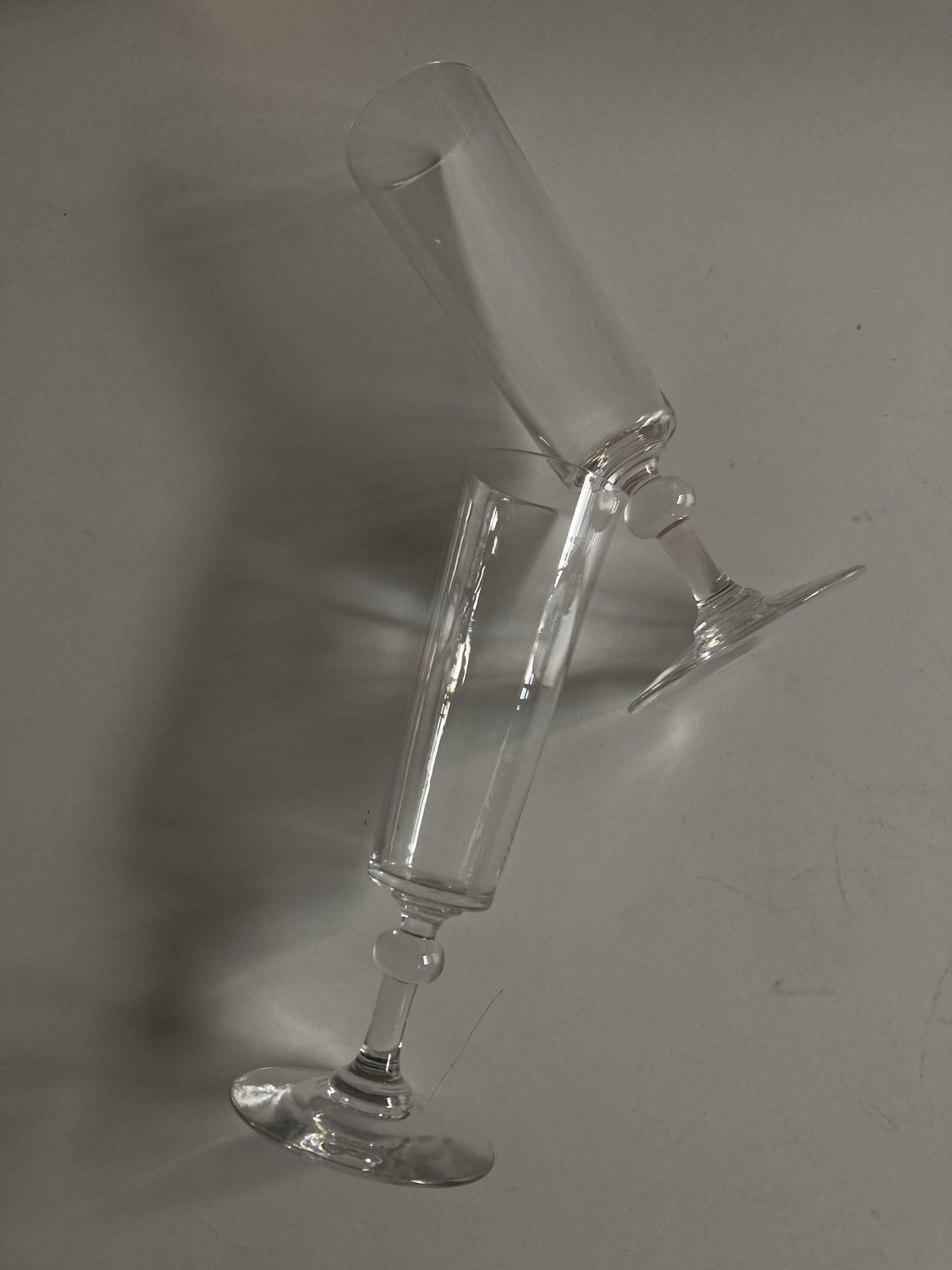 Pair of crystal champagne flutes with a button foot, 1960.
