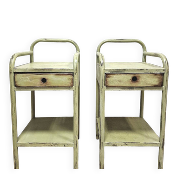Copy of a pair of patinated metal bedside tables.