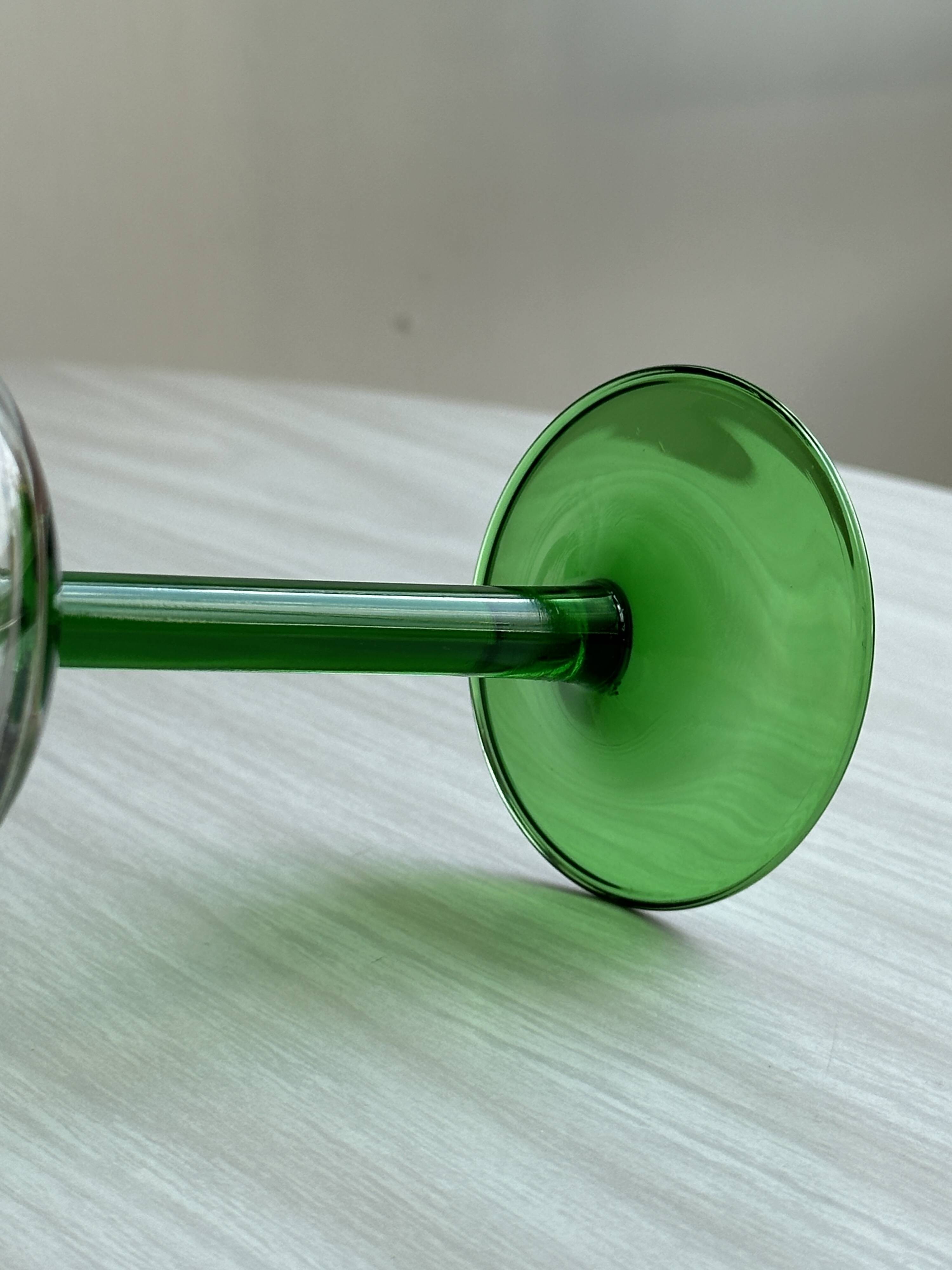 8 Alsatian stemmed glasses, transparent glass and green stems.