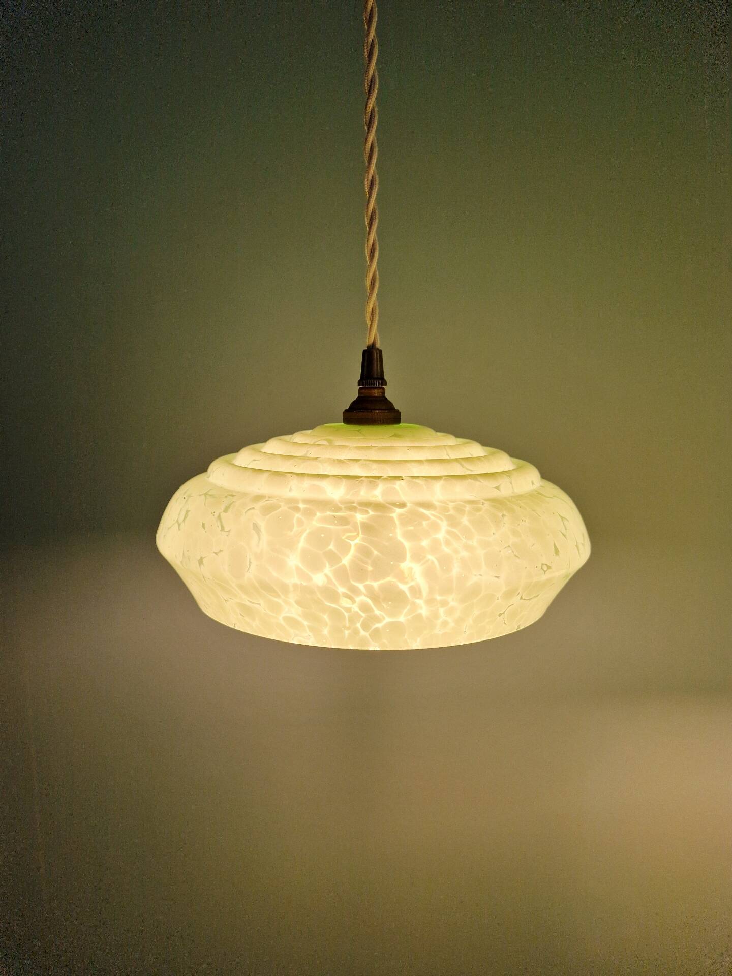 Pair of Art Deco light fixtures in light green speckled glass, 1930s.