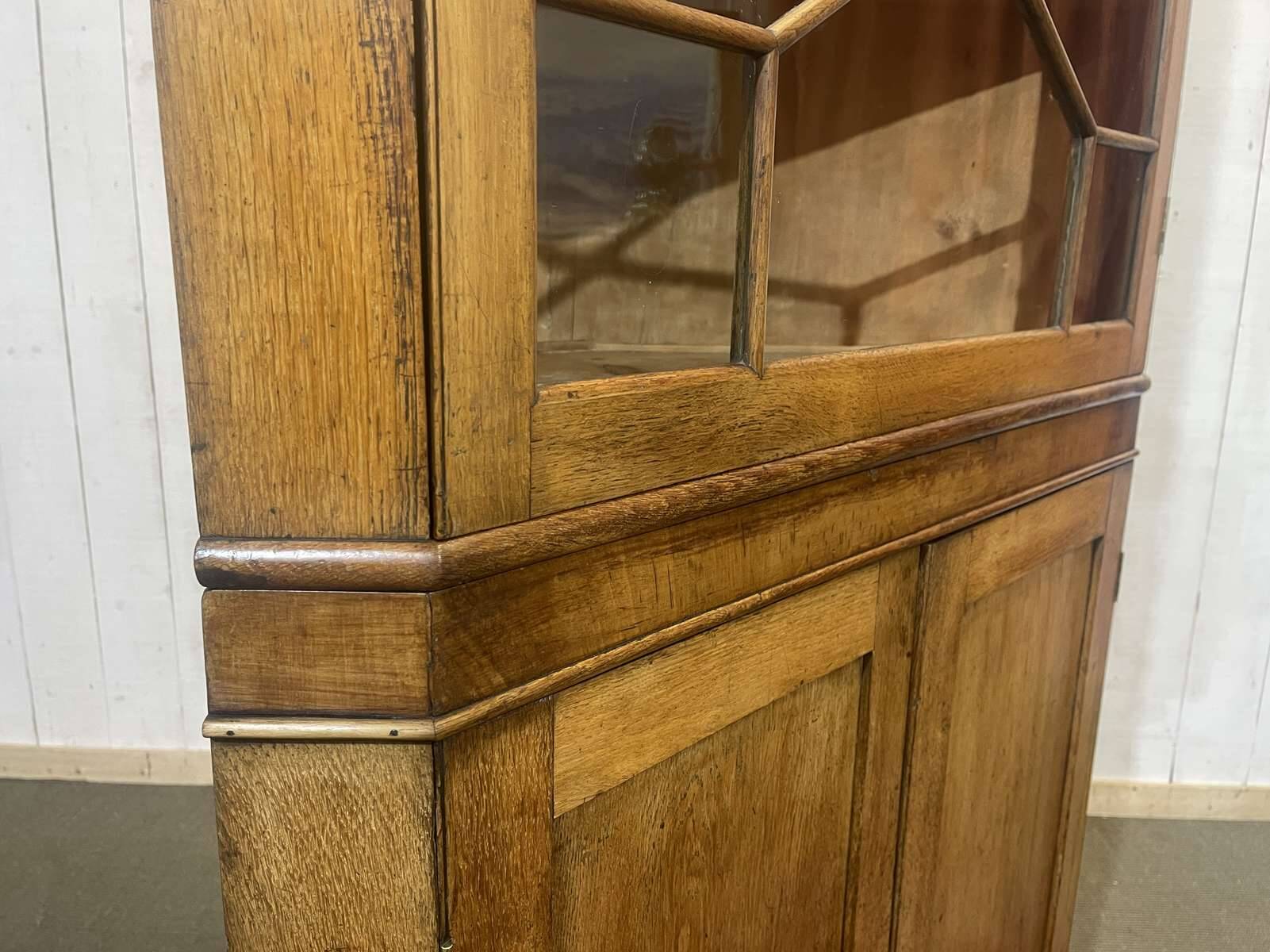 19th-century English corner cabinet in oak, mahogany, and fir.