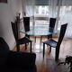 For sale: bevelled glass table and Artedi leather chairs.