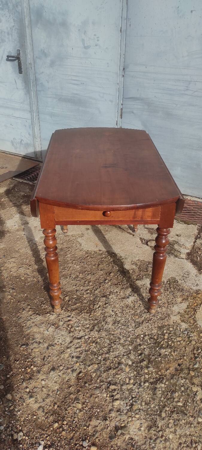 Old extendable round table in fruit wood with folding sides