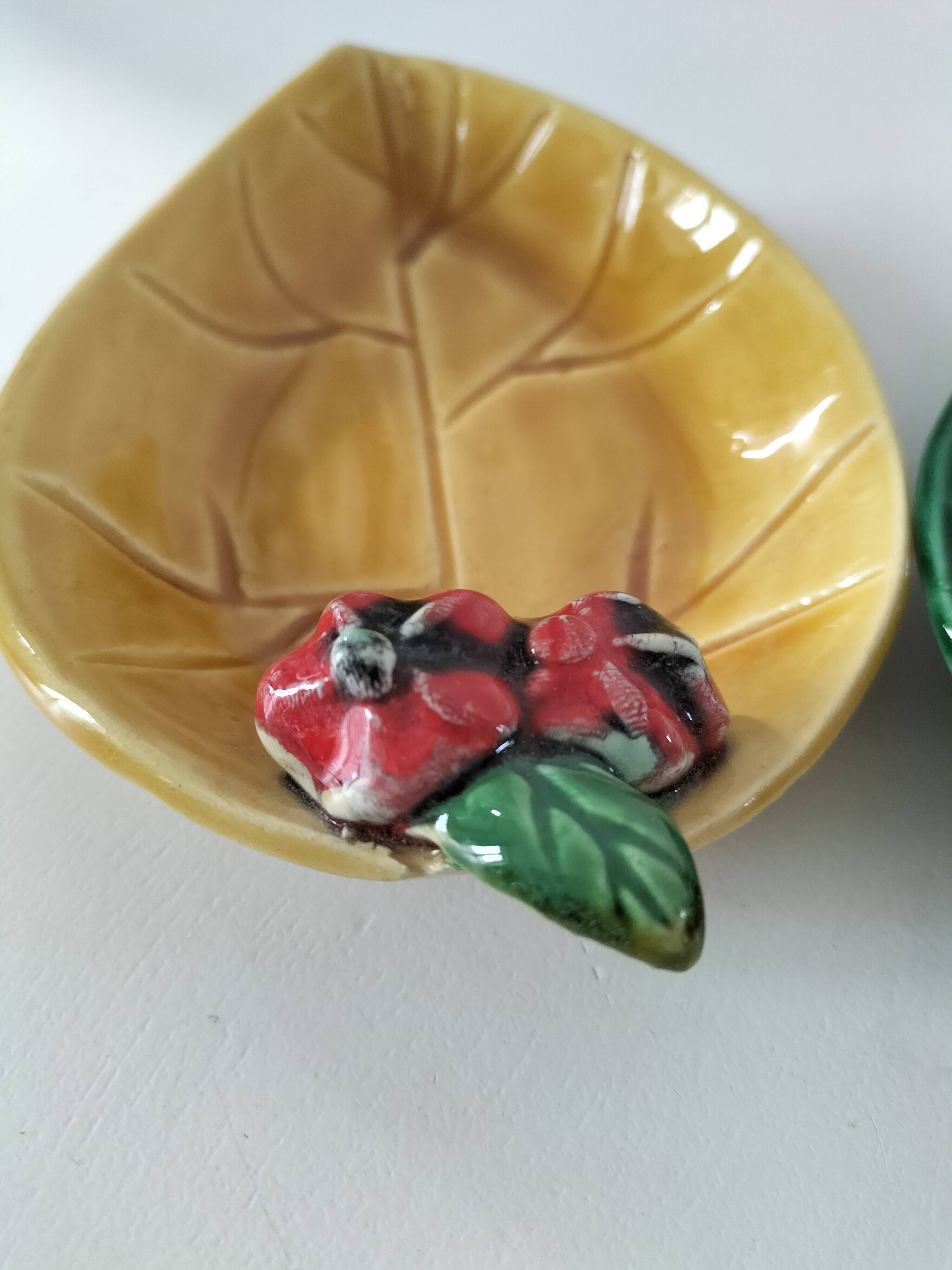 Two relief bowls with leaf designs, radishes, and tomatoes.