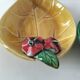 Two relief bowls with leaf designs, radishes, and tomatoes.