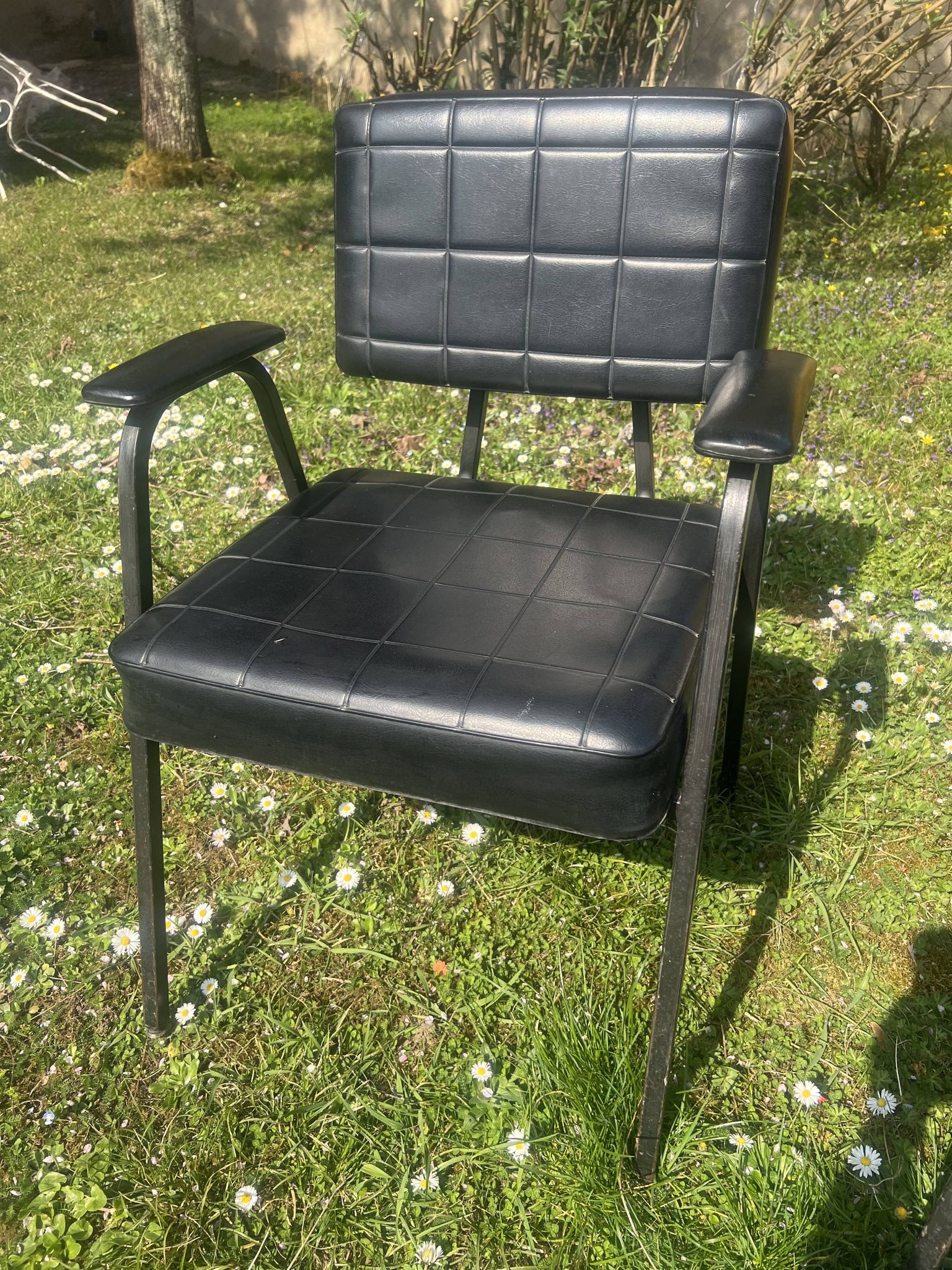 Pair of vintage industrial armchairs in black imitation leather and metal legs