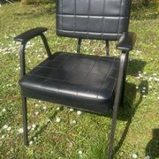 Pair of vintage industrial armchairs in black imitation leather and metal legs