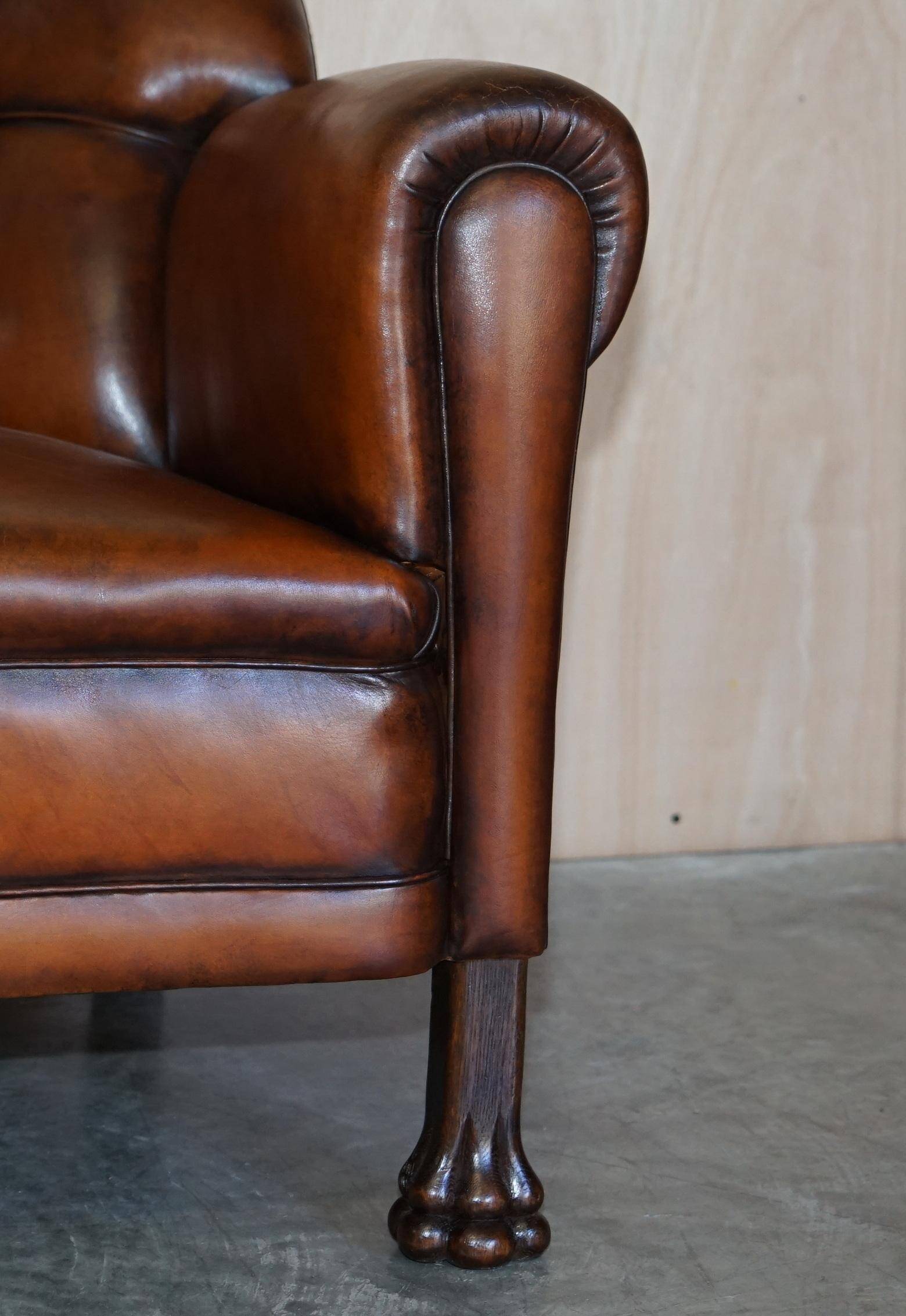 Victorian Chesterfield leather canapé with oak lion claw feet.