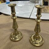 2 gold colored candlesticks
