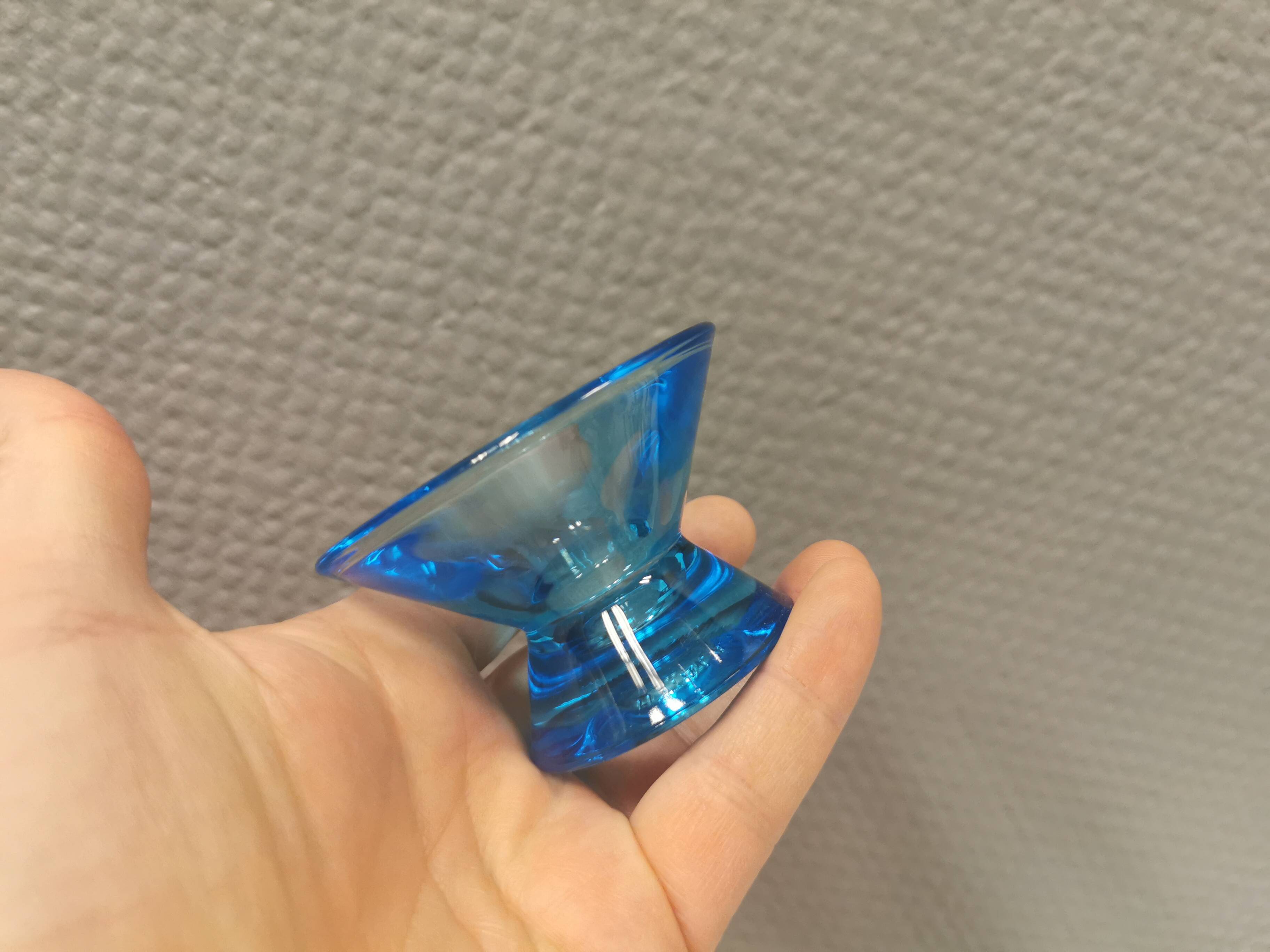 Two small candle holders in blue glass from the well-known Finnish company Ittala.