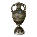 Bronze vase with snakes and a green patina, in the antique style.