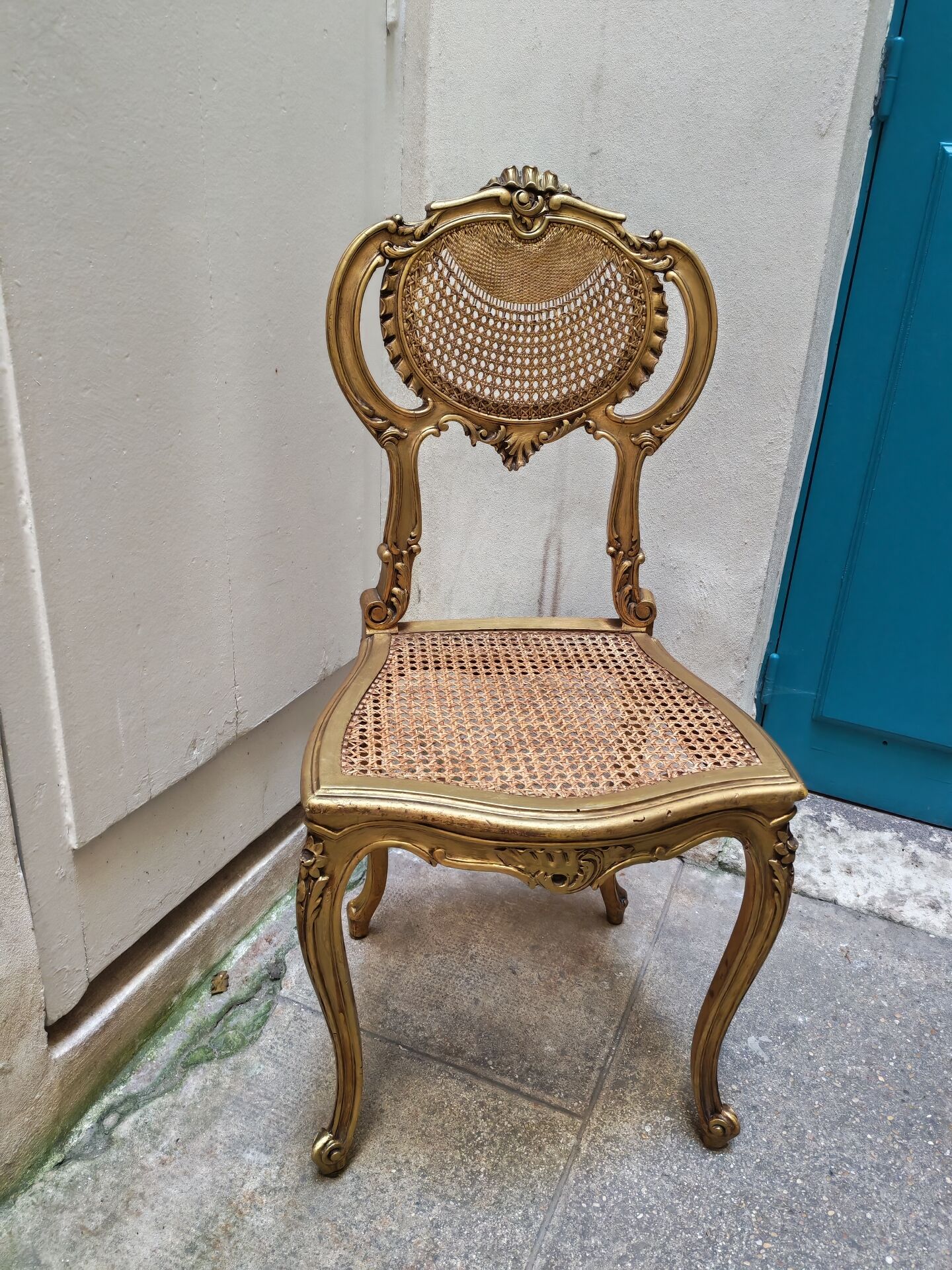 Antique rococo chair in gilded wood and caning