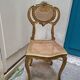 Antique rococo chair in gilded wood and caning