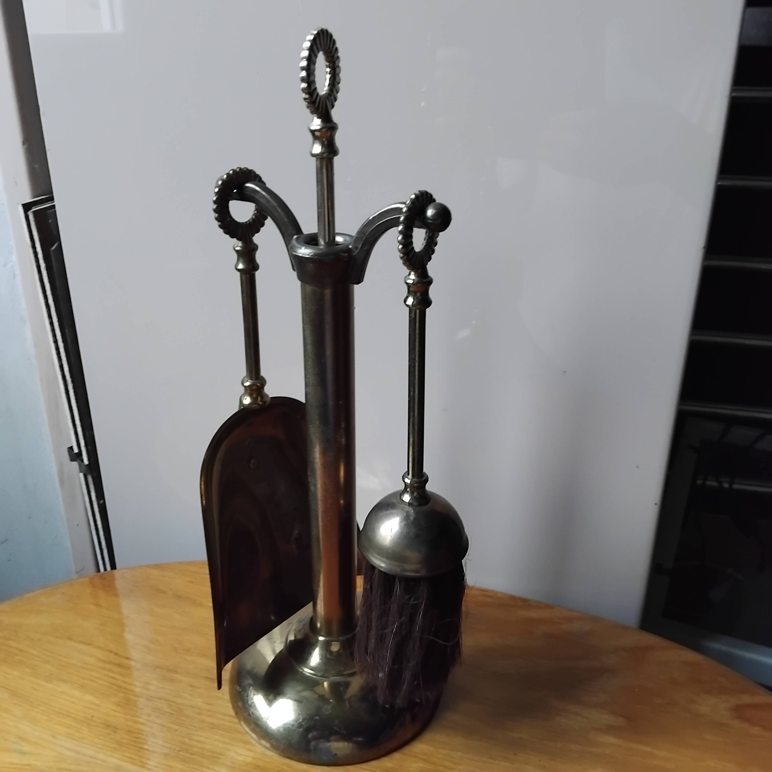 Small and discreet brass fireplace tool set.