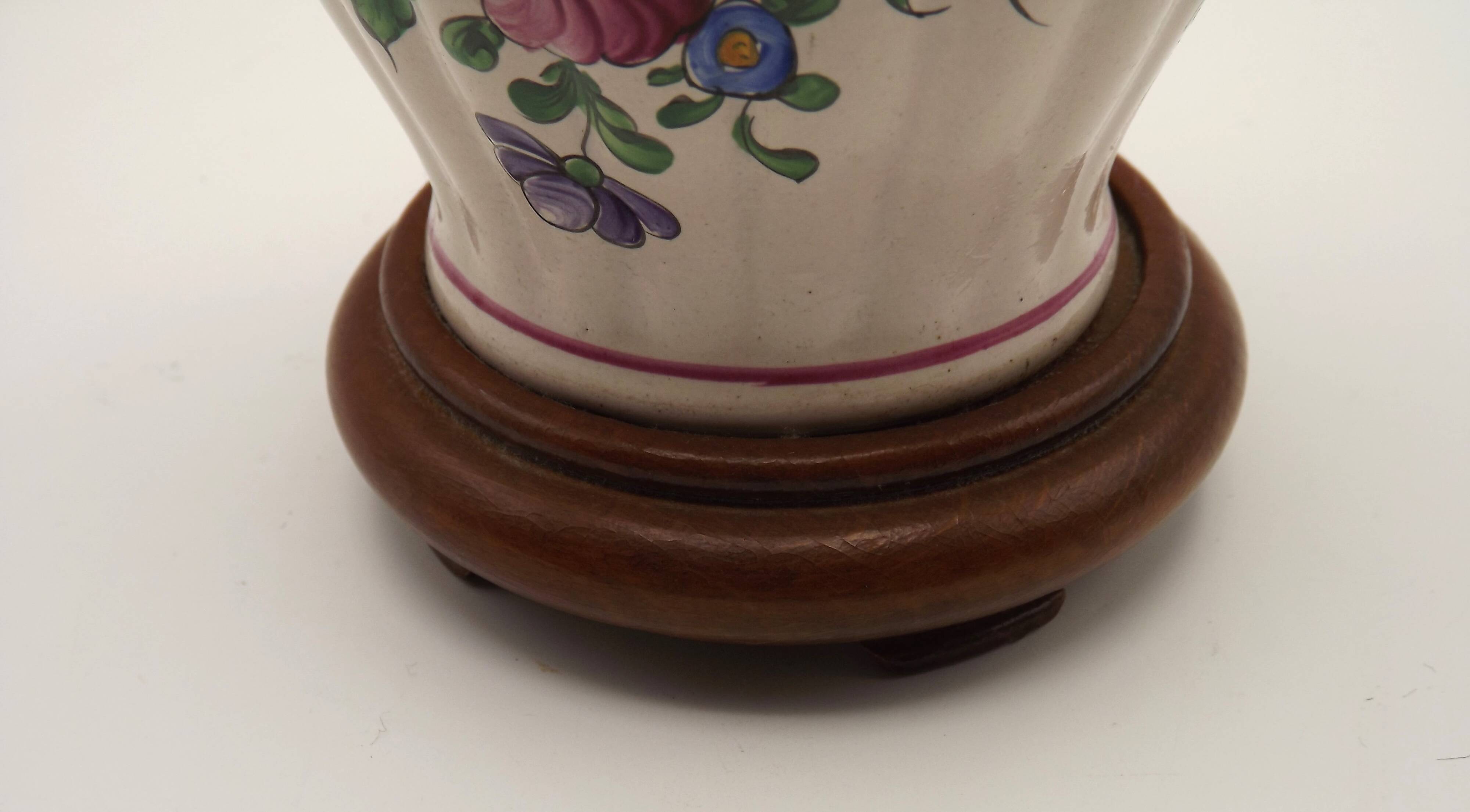 Pretty French vintage hand-painted ceramic floral lamp base on wooden plinth.