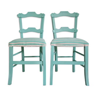 Pair of blue wooden chairs sitting stripes