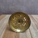 Antique brass candlestick with patina, openwork vintage foliage decoration.