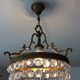 Old chandelier with bronze stamps
