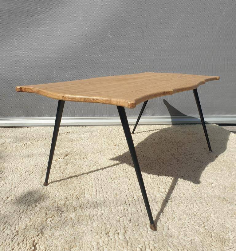 Violin-shaped coffee table with brass legs