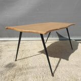 Violin-shaped coffee table with brass legs