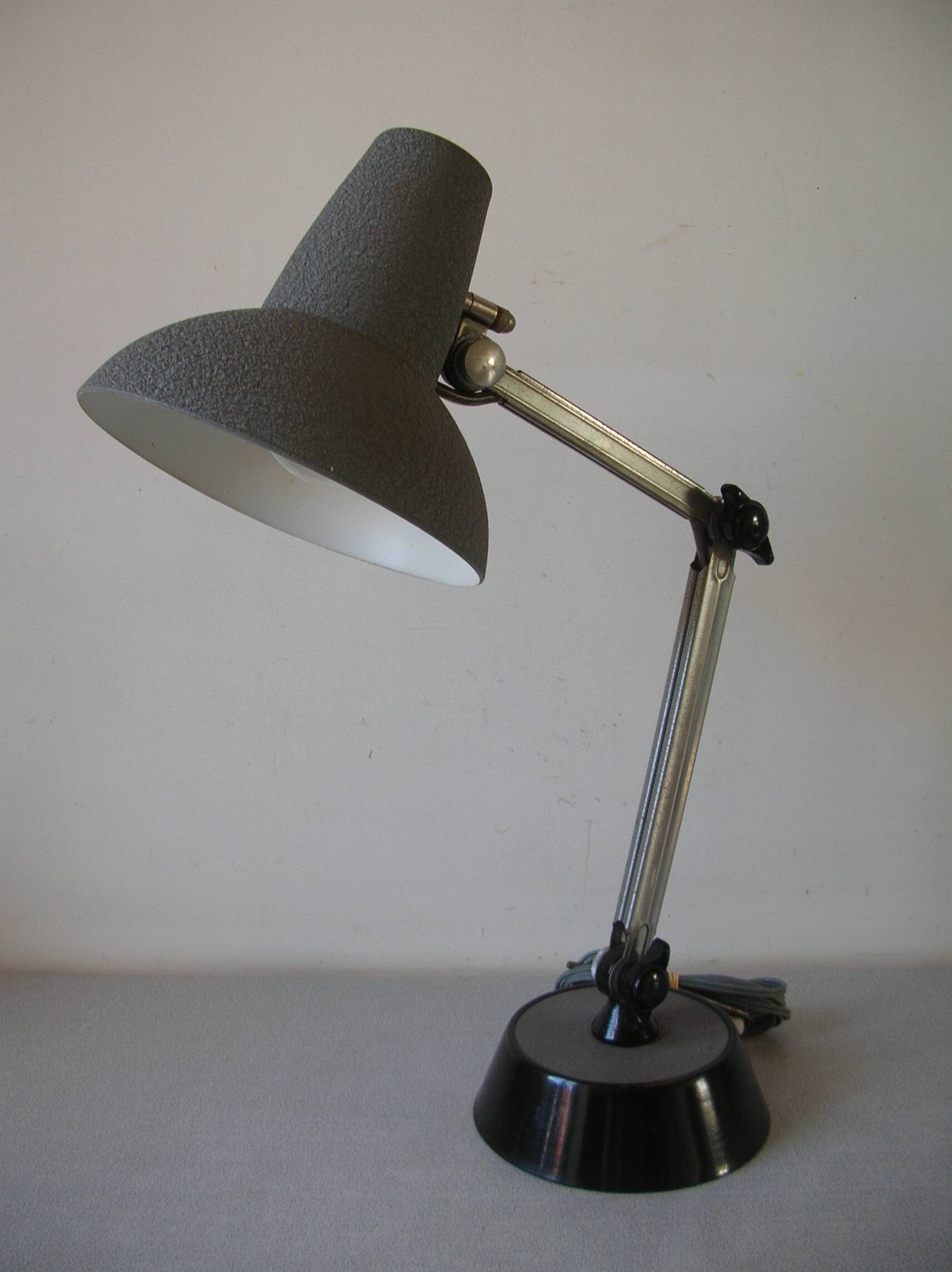 Super Chrome old articulated metal desk lamp on workshop decor base