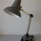 Super Chrome old articulated metal desk lamp on workshop decor base