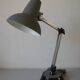 Super Chrome old articulated metal desk lamp on workshop decor base