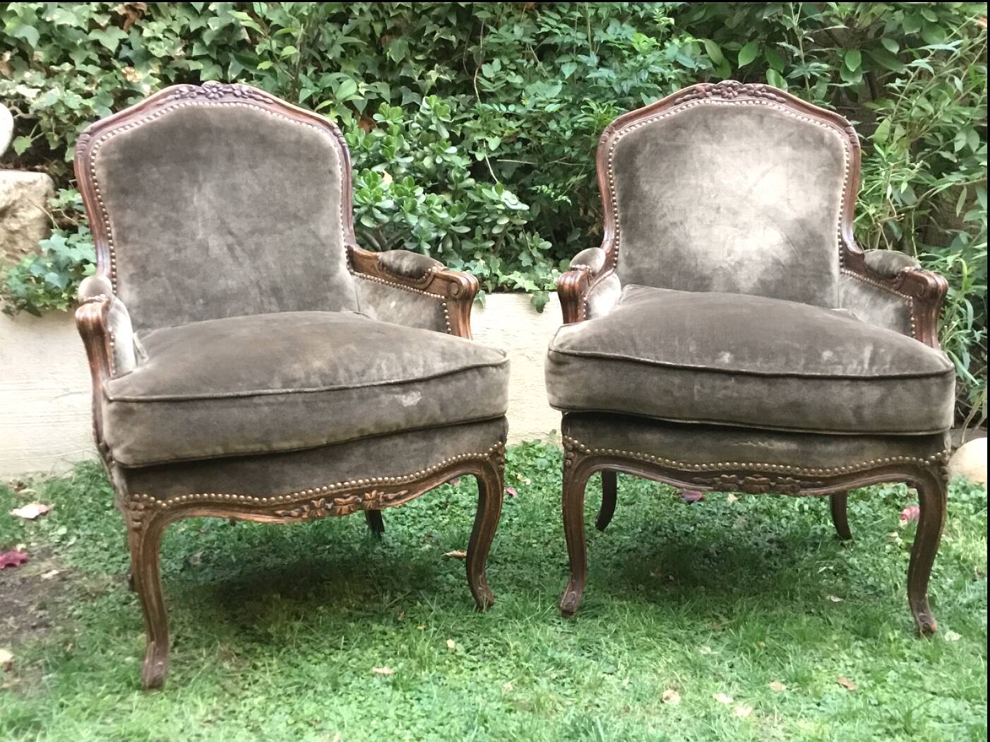 Pair of Louis XV style bergères in moulded and carved wood.