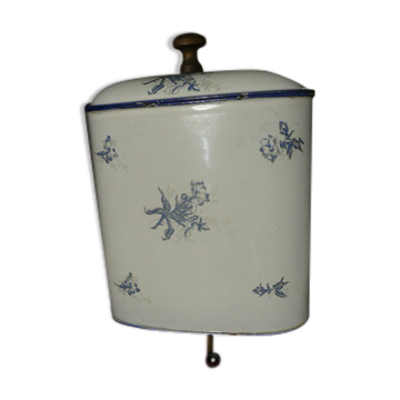 Old wall fountain in enamelled sheet metal decorated with blue flowers on a white background