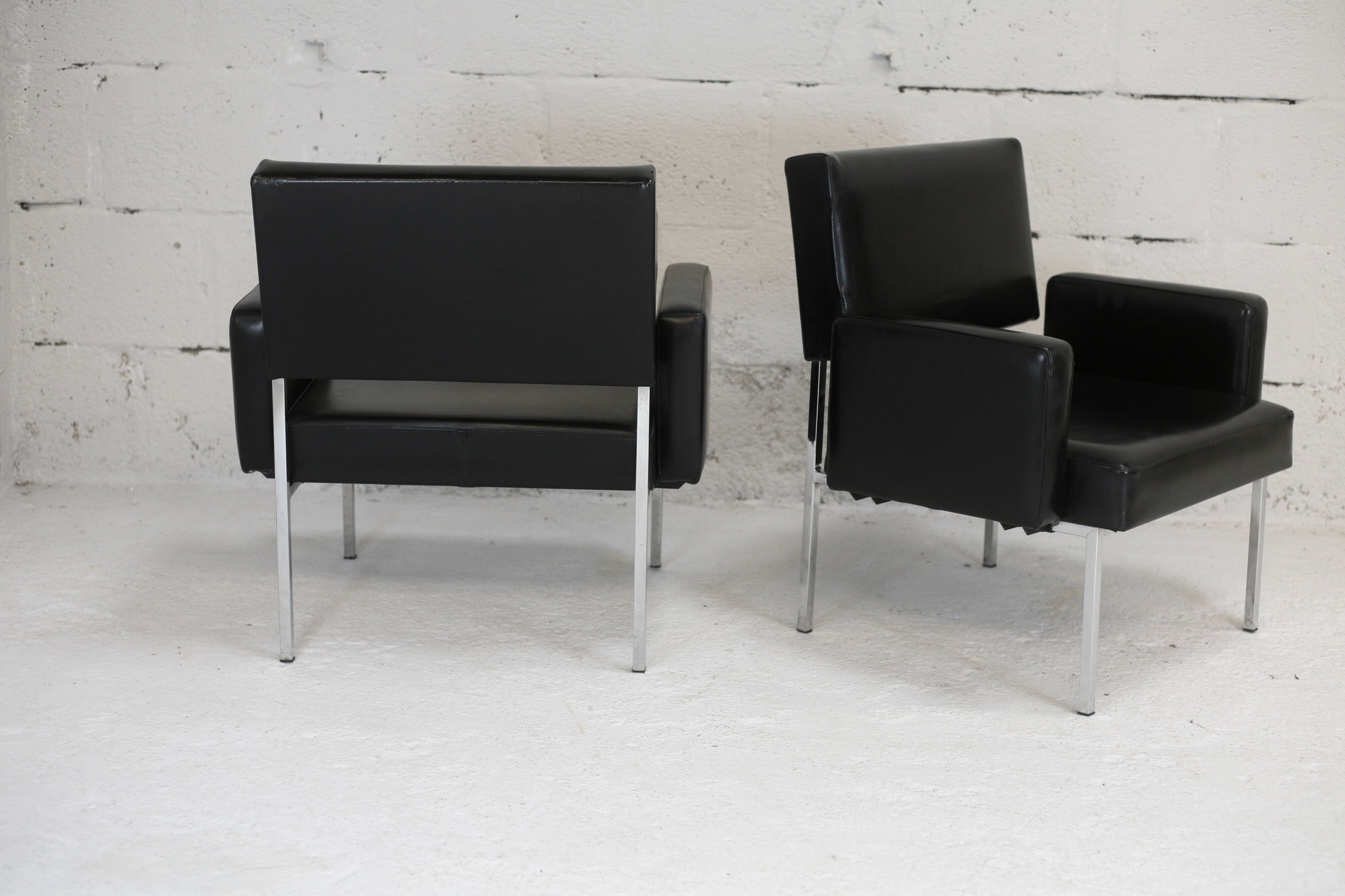 Pair of stainless steel, black leather-like armchairs, France, circa 1970