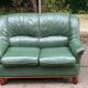 Vintage 2-seater sofa in green leather and solid wood